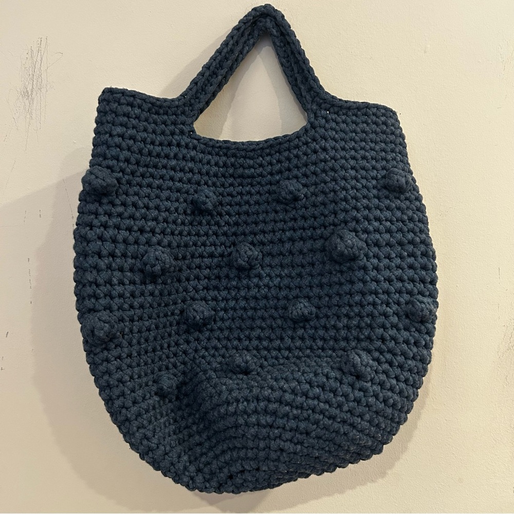 Hand-crocheted blue tote bag with bobble stitch details.